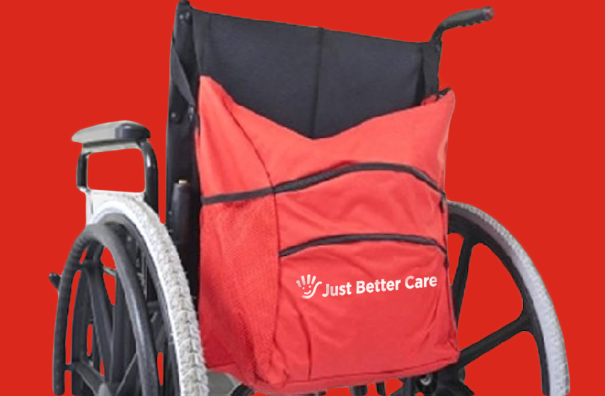 A red backpack with the Just Better Care logo on a wheelchair